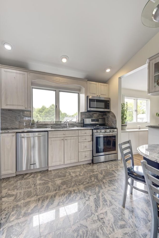 27 Suzanne Ln, Bethpage, NY 11714 - kitchen with appliances with stainless steel finishes, backsplash, a sink, recessed lighting, and light stone countertops