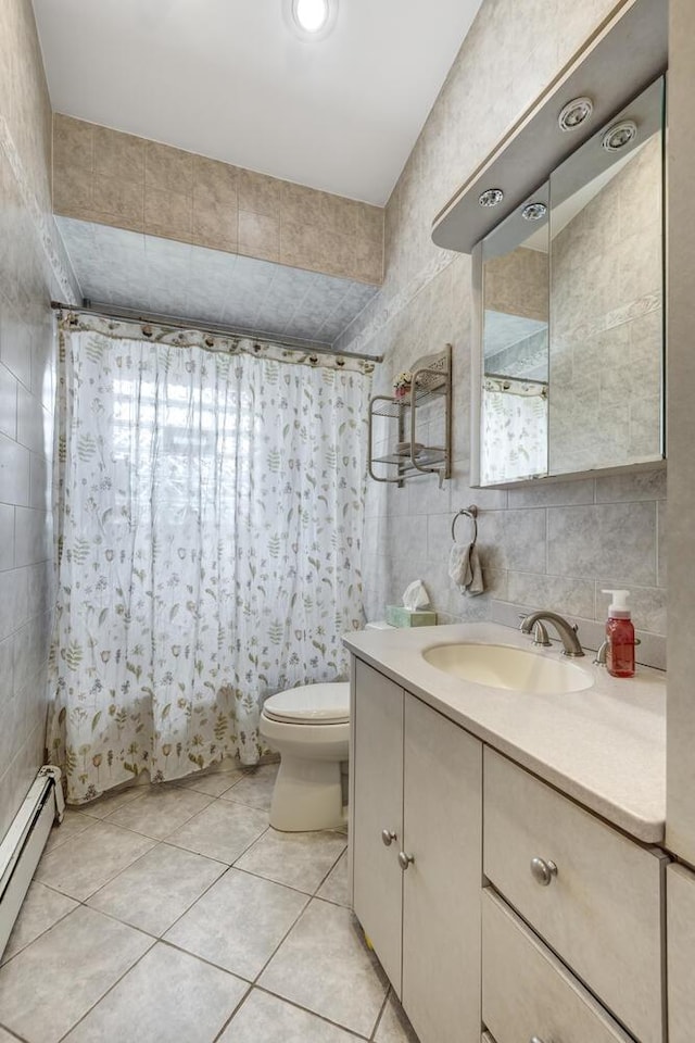 27 Suzanne Ln, Bethpage, NY 11714 - full bathroom featuring a baseboard heating unit, tile walls, tile patterned floors, vanity, and toilet