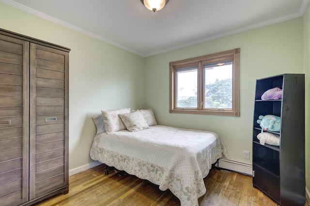 27 Suzanne Ln, Bethpage, NY 11714 - bedroom with a baseboard heating unit, ornamental molding, hardwood / wood-style flooring, and baseboards