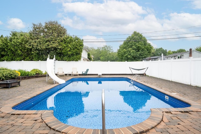 27 Suzanne Ln, Bethpage, NY 11714 - view of pool with a water slide, a patio area, and a fenced backyard
