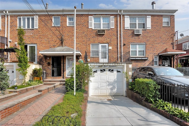 69-14 61st Rd, Middle Village, NY 11379 - view of property with an attached garage, brick siding, driveway, and cooling unit
