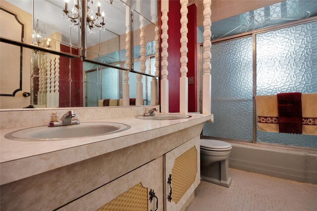 69-14 61st Rd, Middle Village, NY 11379 - full bathroom with double vanity, bath / shower combo with glass door, toilet, and tile patterned flooring