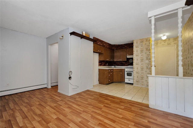 69-14 61st Rd, Middle Village, NY 11379 - kitchen with white range, light wood-type flooring, light countertops, and baseboards
