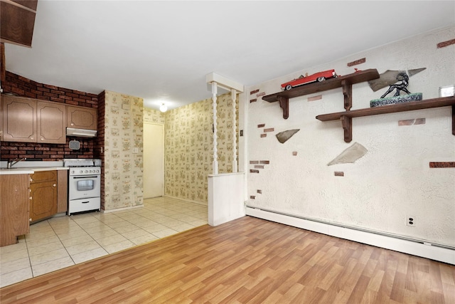 69-14 61st Rd, Middle Village, NY 11379 - kitchen featuring white gas range oven, under cabinet range hood, baseboard heating, open shelves, and light countertops