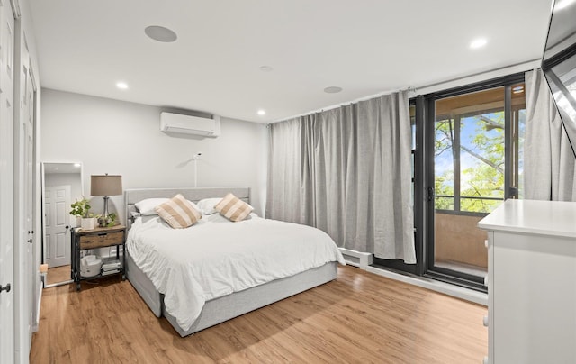 1101 162nd St Unit 6C, Beechhurst, NY 11357 - bedroom featuring a wall mounted AC, light wood-style floors, access to exterior, and recessed lighting