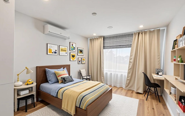 1101 162nd St Unit 6C, Beechhurst, NY 11357 - bedroom with a wall mounted air conditioner, an office area, light wood finished floors, and recessed lighting