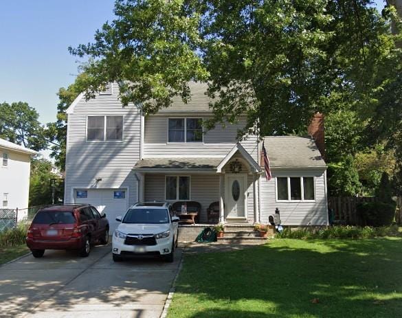 517 Birch St, West Hempstead, NY 11552 - view of front of home with driveway, an attached garage, and a chimney