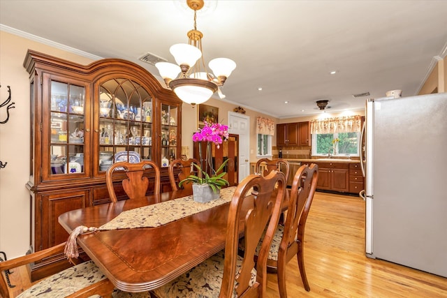 517 Birch St, West Hempstead, NY 11552 - dining room featuring crown molding, a chandelier, light wood-type flooring, and recessed lighting