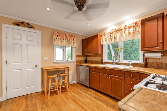517 Birch St, West Hempstead, NY 11552 - kitchen with dishwasher, ornamental molding, brown cabinets, light wood finished floors, and tasteful backsplash
