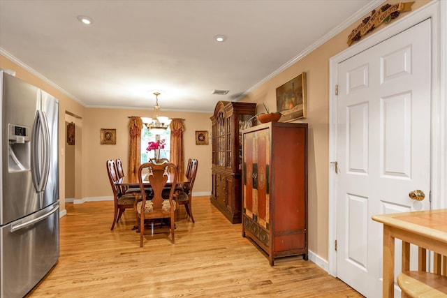 517 Birch St, West Hempstead, NY 11552 - dining space featuring a chandelier, light wood finished floors, crown molding, and recessed lighting