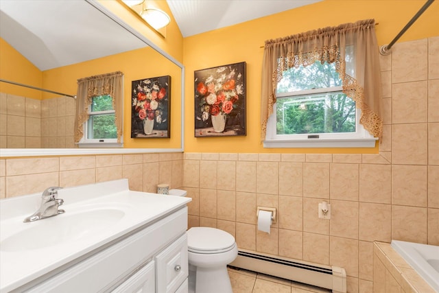 517 Birch St, West Hempstead, NY 11552 - full bath featuring a baseboard heating unit, tile walls, vanity, vaulted ceiling, and tile patterned floors