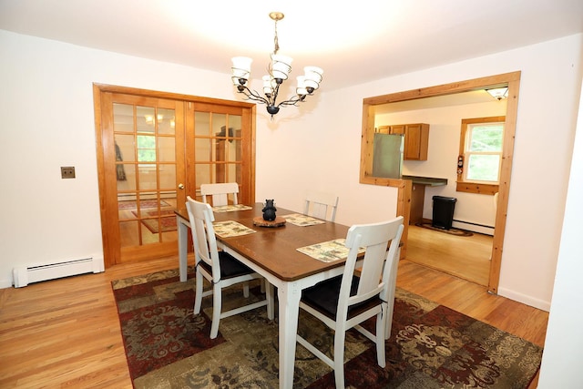 342 Bernas Rd, Cochecton, NY 12726 - dining room featuring a baseboard heating unit, a chandelier, and light wood-style flooring