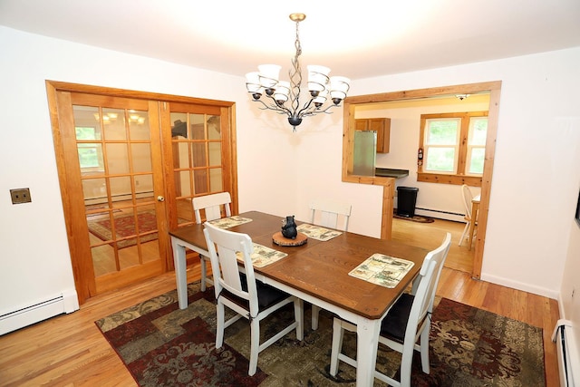 342 Bernas Rd, Cochecton, NY 12726 - dining room with a baseboard heating unit, a chandelier, and light wood-type flooring