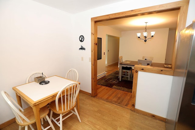 342 Bernas Rd, Cochecton, NY 12726 - dining space with a chandelier, a baseboard heating unit, light wood-type flooring, and baseboards