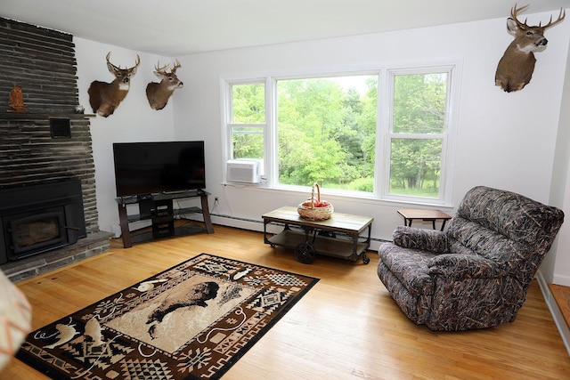 342 Bernas Rd, Cochecton, NY 12726 - living area featuring wood finished floors, cooling unit, and a stone fireplace