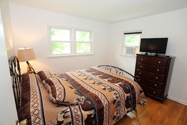 342 Bernas Rd, Cochecton, NY 12726 - bedroom with wood finished floors, cooling unit, and baseboards