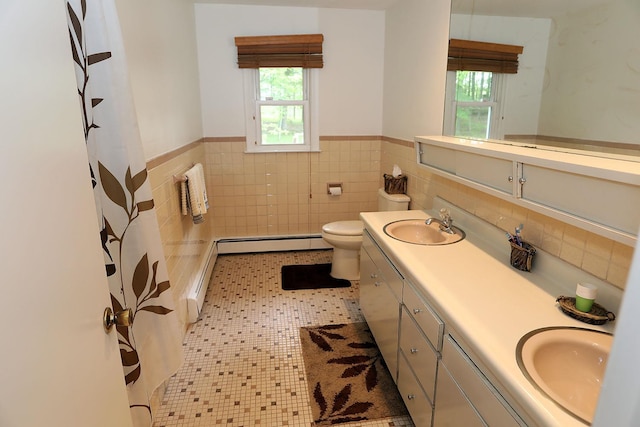 342 Bernas Rd, Cochecton, NY 12726 - bathroom with double vanity, healthy amount of natural light, baseboard heating, wainscoting, and tile walls