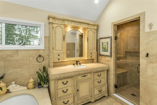 16 Abbey Ln, East Setauket, NY 11733 - full bathroom featuring vaulted ceiling, vanity, a shower stall, tile patterned floors, and tile walls