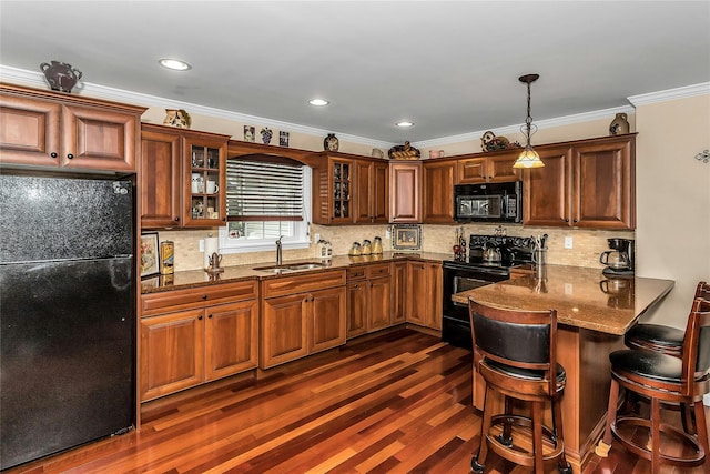 16 Abbey Ln, East Setauket, NY 11733 - kitchen with black appliances, a sink, a peninsula, dark wood finished floors, and glass insert cabinets