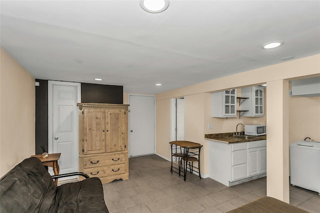 16 Abbey Ln, East Setauket, NY 11733 - kitchen featuring white microwave, dark countertops, glass insert cabinets, a sink, and recessed lighting