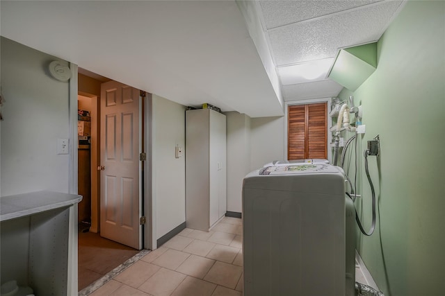16 Abbey Ln, East Setauket, NY 11733 - washroom with washer / dryer, light tile patterned floors, and baseboards