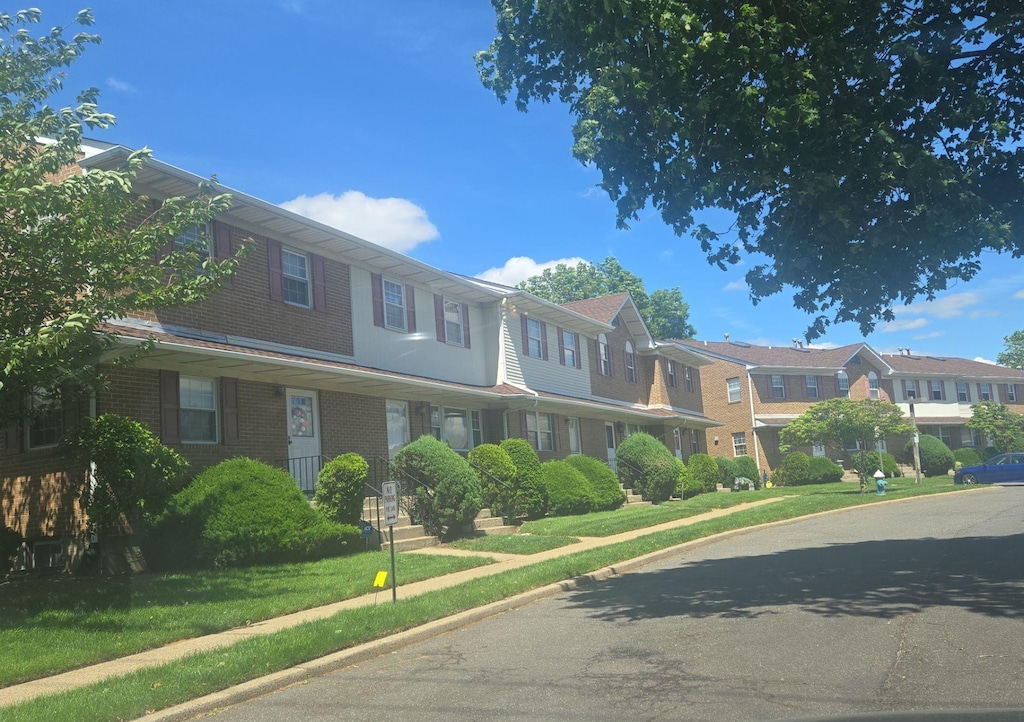 815 Franklin Ave Unit 4, Franklin Square, NY 11010 - view of asphalt road with a residential view, sidewalks, and curbs