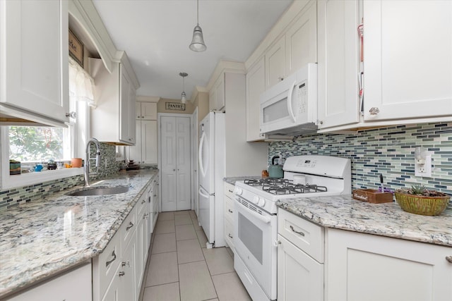 487 Sunnybrook Dr, Oceanside, NY 11572 - kitchen with white appliances, a sink, light tile patterned flooring, tasteful backsplash, and white cabinetry