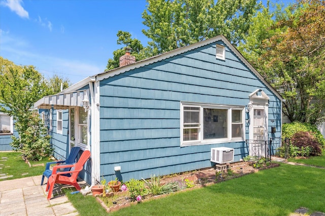 487 Sunnybrook Dr, Oceanside, NY 11572 - view of side of home featuring a chimney and a yard