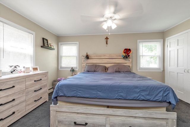 487 Sunnybrook Dr, Oceanside, NY 11572 - bedroom with carpet flooring, multiple windows, a ceiling fan, and a baseboard heating unit