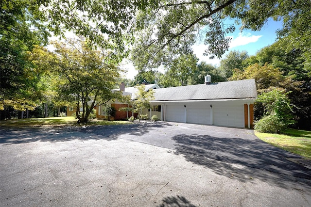 94 Cedar Ave, Poughkeepsie, NY 12603 - single story home with a chimney, an attached garage, and asphalt driveway