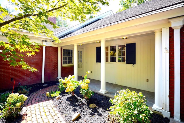 94 Cedar Ave, Poughkeepsie, NY 12603 - view of exterior entry with brick siding and a shingled roof