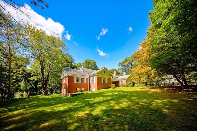 94 Cedar Ave, Poughkeepsie, NY 12603 - back of house with a yard, a chimney, and brick siding