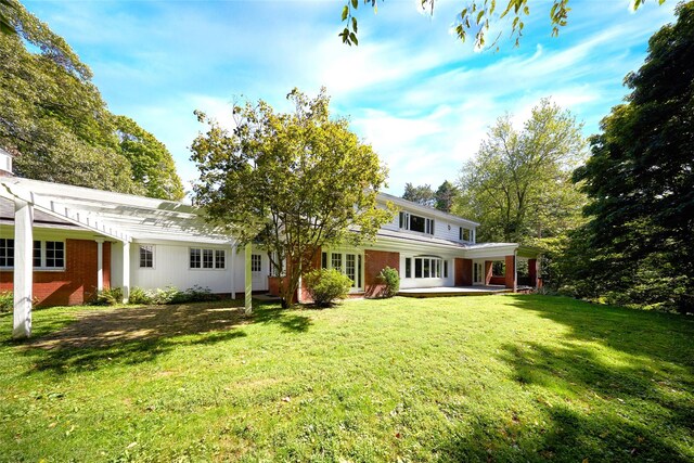 94 Cedar Ave, Poughkeepsie, NY 12603 - back of property featuring a yard and brick siding