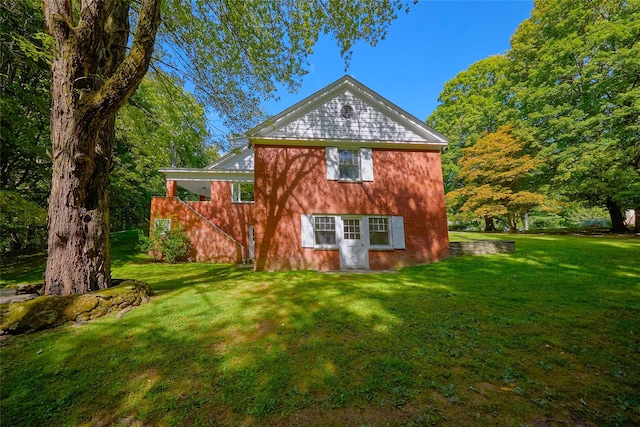 94 Cedar Ave, Poughkeepsie, NY 12603 - rear view of property featuring a lawn and brick siding