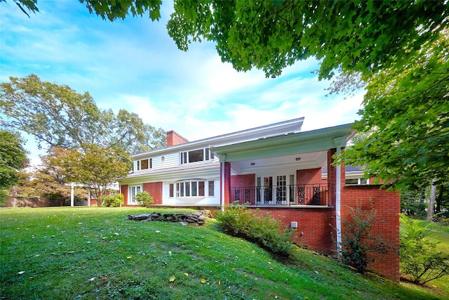 94 Cedar Ave, Poughkeepsie, NY 12603 - back of property with brick siding, a chimney, and a lawn