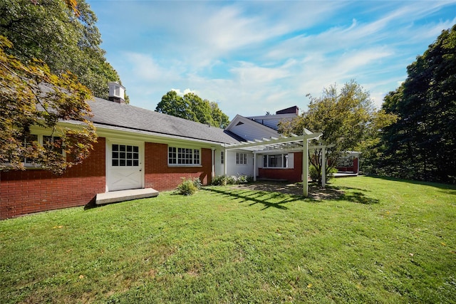 94 Cedar Ave, Poughkeepsie, NY 12603 - back of house with a chimney, a pergola, brick siding, and a yard