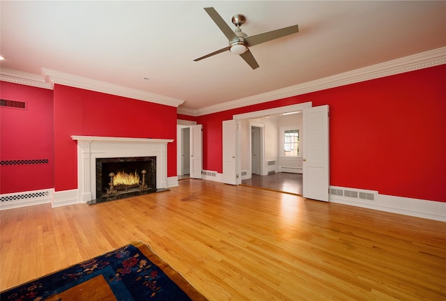 94 Cedar Ave, Poughkeepsie, NY 12603 - unfurnished living room featuring ceiling fan, a premium fireplace, crown molding, wood finished floors, and a baseboard radiator