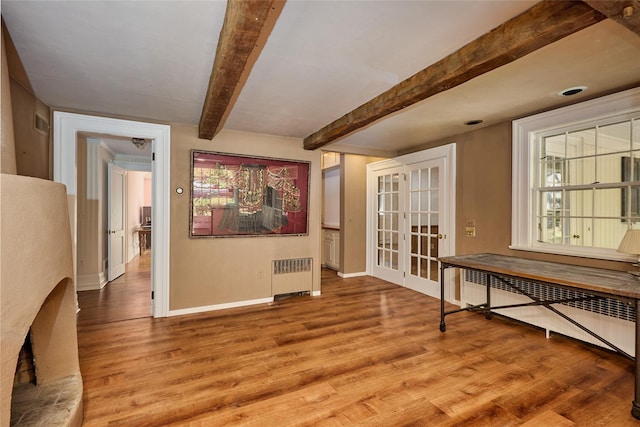 94 Cedar Ave, Poughkeepsie, NY 12603 - unfurnished room with radiator, french doors, baseboards, wood finished floors, and beamed ceiling