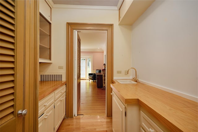 94 Cedar Ave, Poughkeepsie, NY 12603 - bar area featuring a sink, ornamental molding, and light wood-style flooring