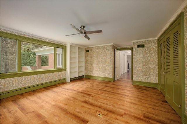 94 Cedar Ave, Poughkeepsie, NY 12603 - unfurnished bedroom with wallpapered walls, a baseboard radiator, crown molding, baseboards, and wood finished floors