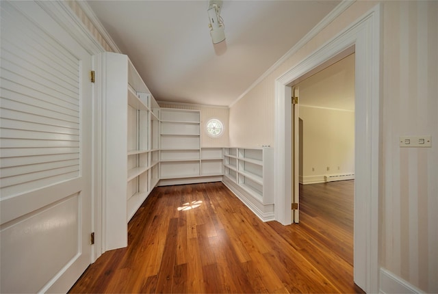 94 Cedar Ave, Poughkeepsie, NY 12603 - hallway featuring built in shelves, crown molding, a baseboard radiator, and wood-type flooring