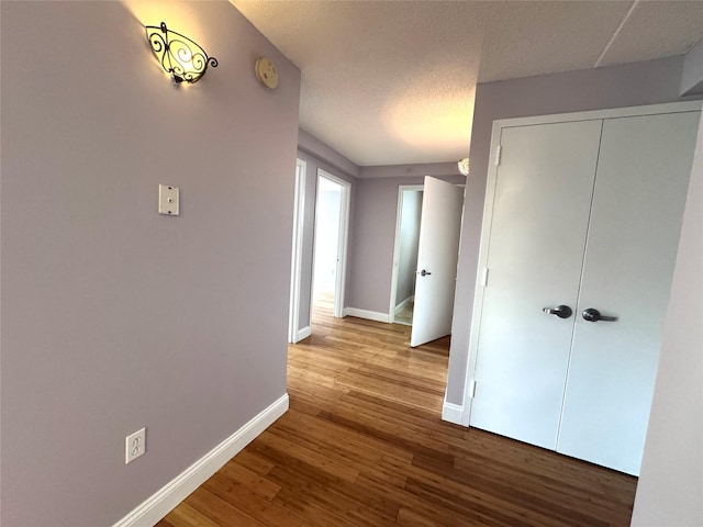 221 Bch 80th St Unit 2J, Rockaway Beach, NY 11693 - hallway featuring baseboards, wood finished floors, and a textured ceiling