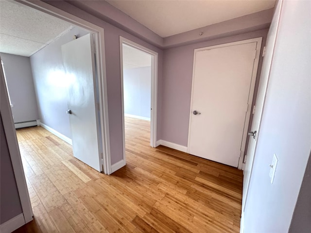 221 Bch 80th St Unit 2J, Rockaway Beach, NY 11693 - hall with a baseboard radiator, light wood-style flooring, and baseboards