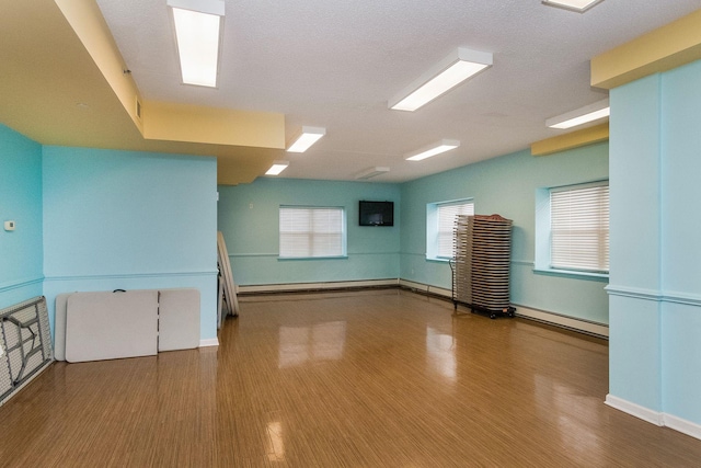 221 Bch 80th St Unit 2J, Rockaway Beach, NY 11693 - empty room featuring baseboard heating, wood finished floors, and baseboards