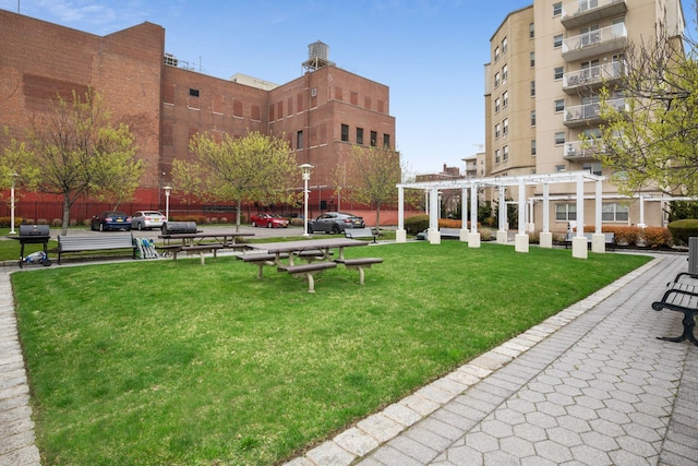 221 Bch 80th St Unit 2J, Rockaway Beach, NY 11693 - view of property's community with a lawn and a pergola