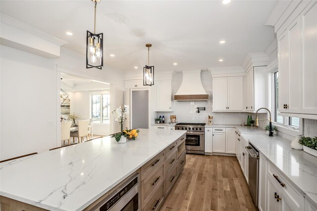 45 Mist Ln, Westbury, NY 11590 - kitchen with premium range hood, stainless steel appliances, a sink, a center island, and tasteful backsplash