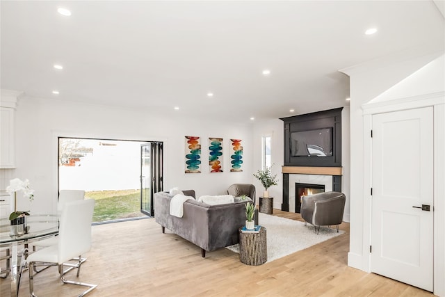45 Mist Ln, Westbury, NY 11590 - living room featuring plenty of natural light, recessed lighting, light wood-type flooring, and a large fireplace