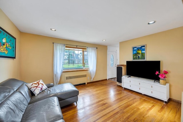 86 Woodbine Dr N, Hicksville, NY 11801 - living room with radiator, light wood-type flooring, and recessed lighting