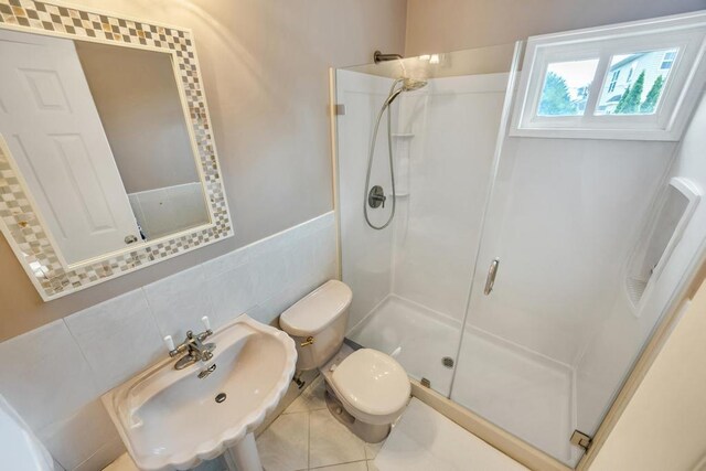 86 Woodbine Dr N, Hicksville, NY 11801 - bathroom with a stall shower, tile walls, and tile patterned flooring