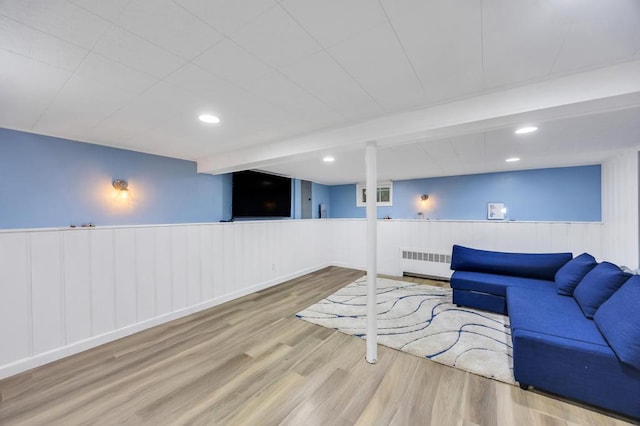86 Woodbine Dr N, Hicksville, NY 11801 - living area featuring radiator, wood finished floors, a wainscoted wall, and recessed lighting